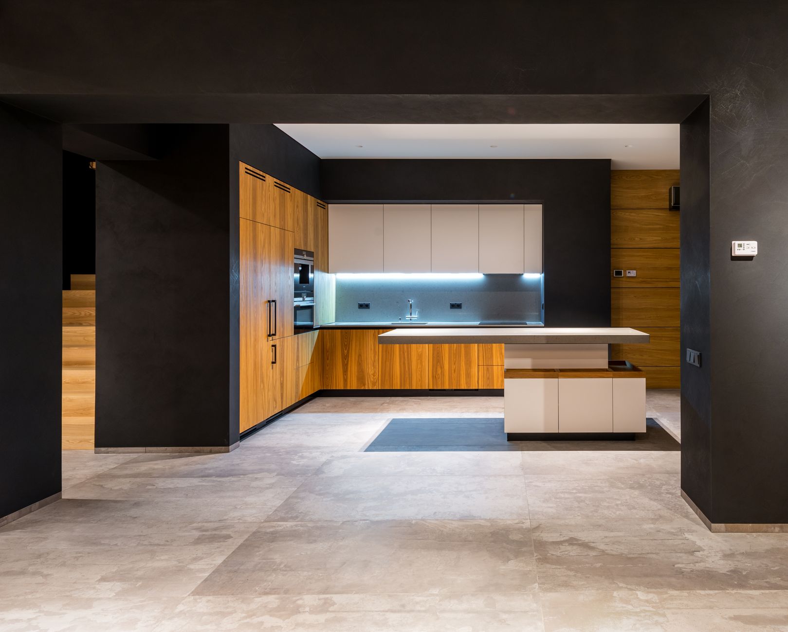 Interior of modern cottage with marble floor and spacious kitchen with wooden furniture and floating in Scottsdale, AZ